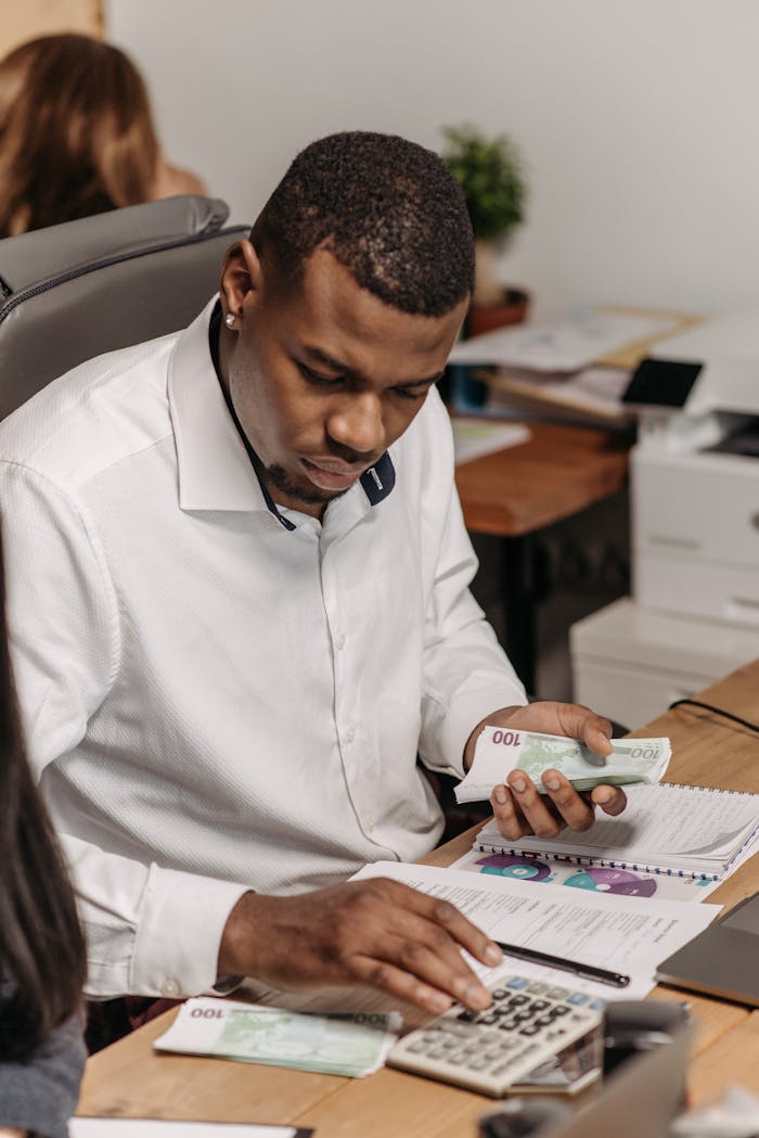 Professional counting money in an office, emphasizing finance and accounting.